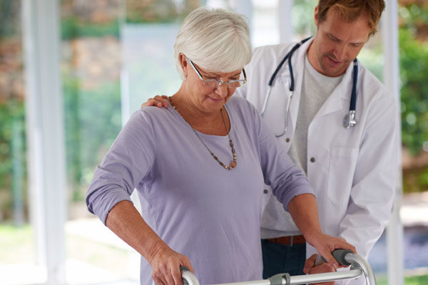 doctor helping patient in rehabilitation